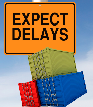 Expect Delays orange sign next to shipping containers