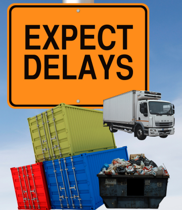 EXPECT DELAYS sign, with garbage, truck and shippng containers 
