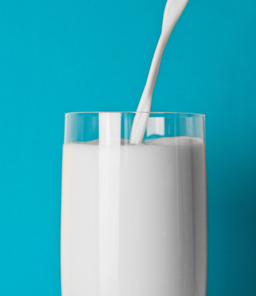 A glass of milk being poured 